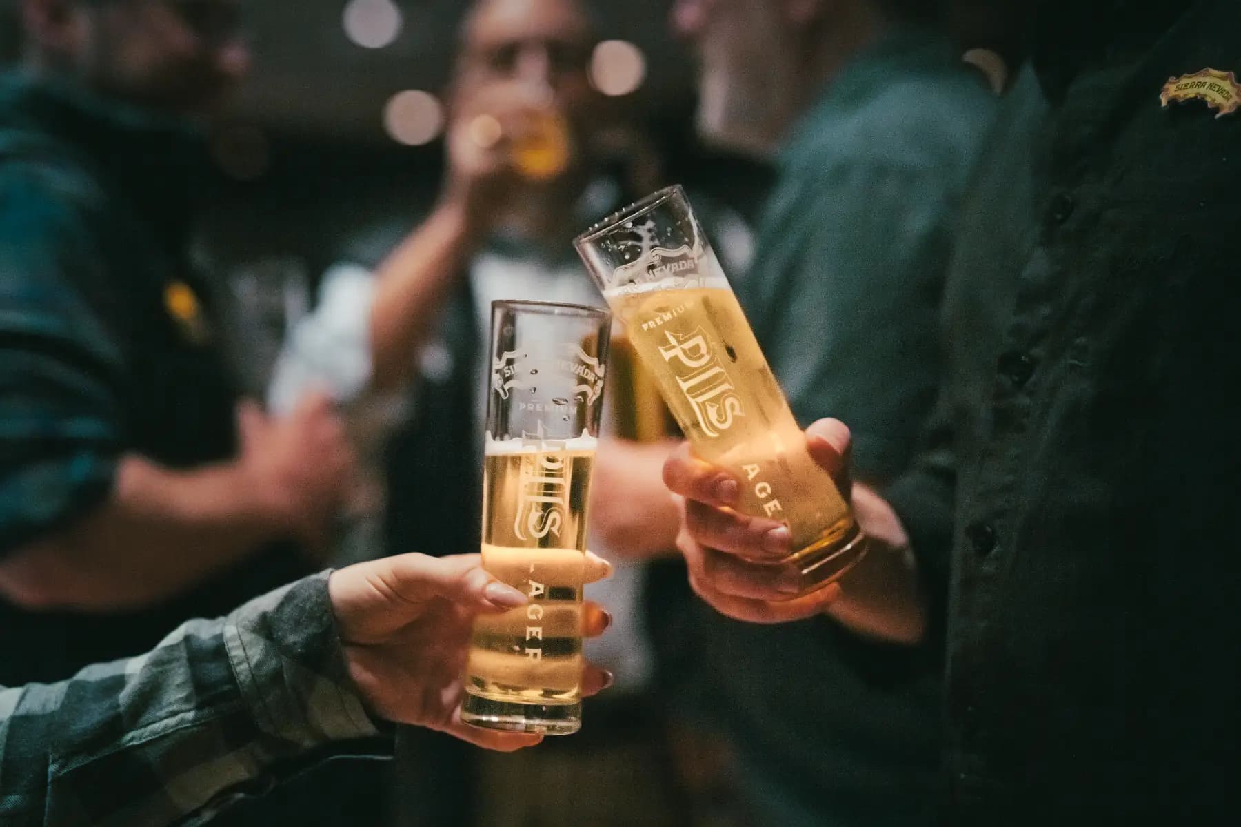 Glasses of PILS cheersed in a taproom