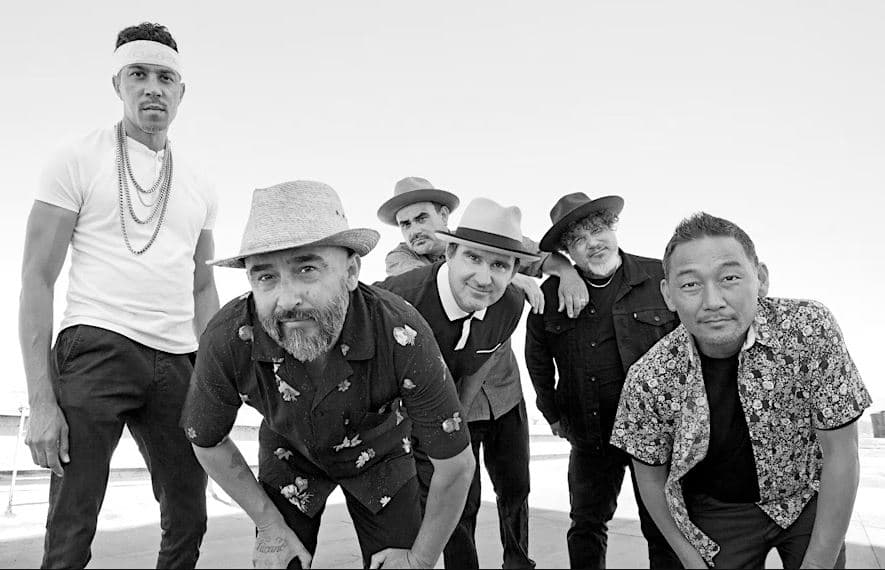 Ozomatli band posing for a picture
