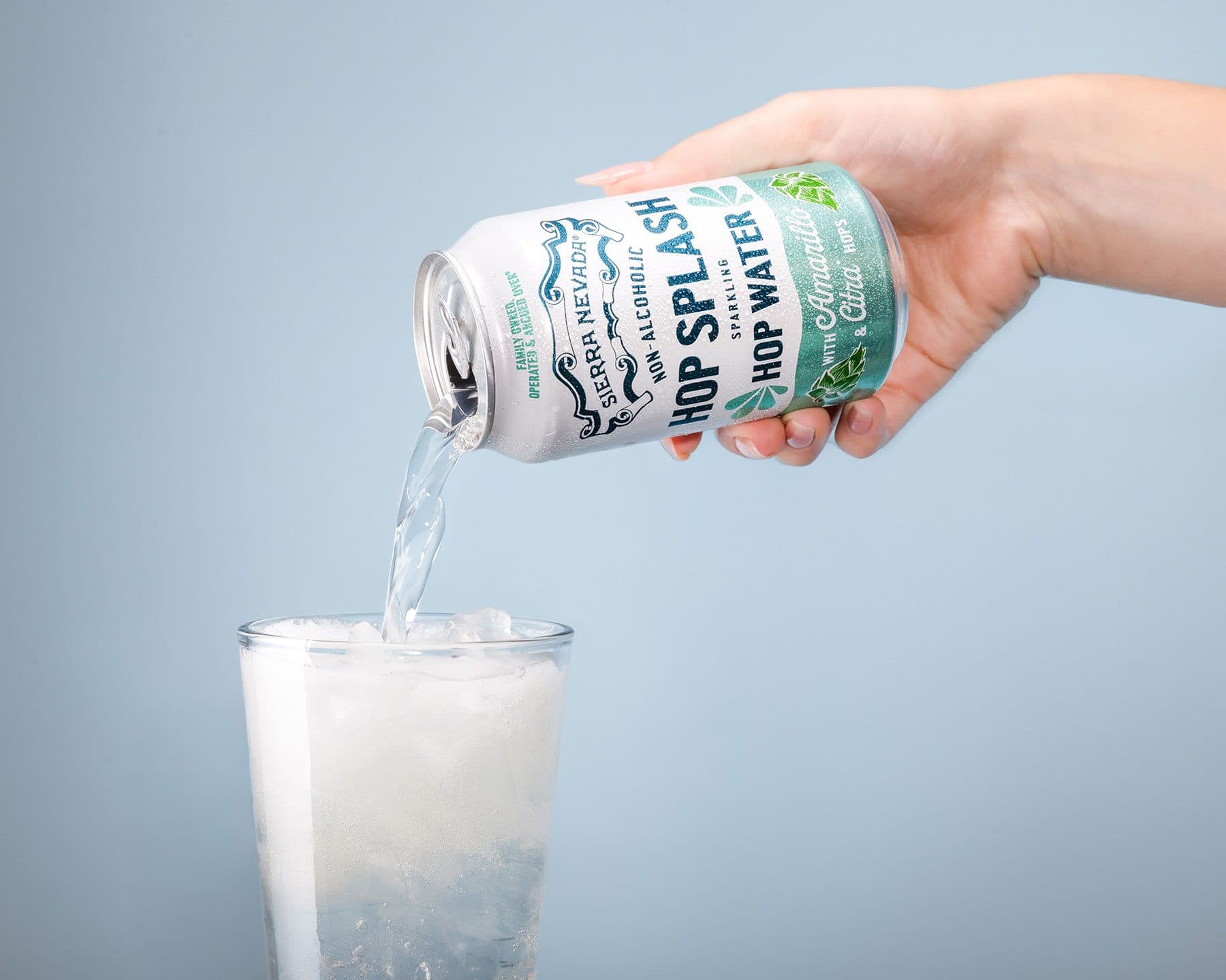 Hand pouring Sierra Nevada non-alcoholic Hop Splash into a glass